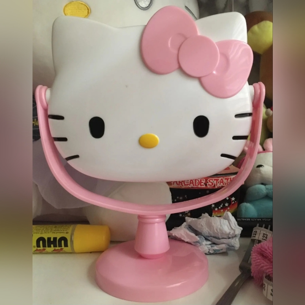 New Hello Kitty pink rotating makeup mirror approximately 9" tall.